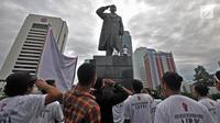 Sejumlah aktivis melakukan penghormatan sambil mengheningkan cipta di depan patung Jenderal Soedirman, Jakarta, Rabu (14/11). Aksi ini dalam rangka memperingati Hari Pahlawan dan menghormati jasa-jasa Jenderal Soedirman. (Merdeka.com/ Iqbal S. Nugroho)