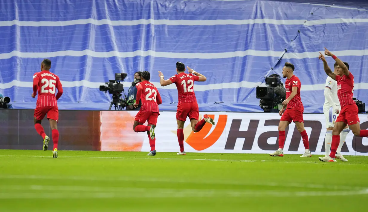 Para pemain Sevilla merayakan gol yang dicetak Rafa Mir (tengah) pada pertandingan lanjutan La Liga Spanyol di di stadion Bernabeu, Madrid, Spanyol, Senin (29/11/2021). Real Madrid menang tipis atas Sevilla 2-1. (AP Photo/Manu Fernandez)
