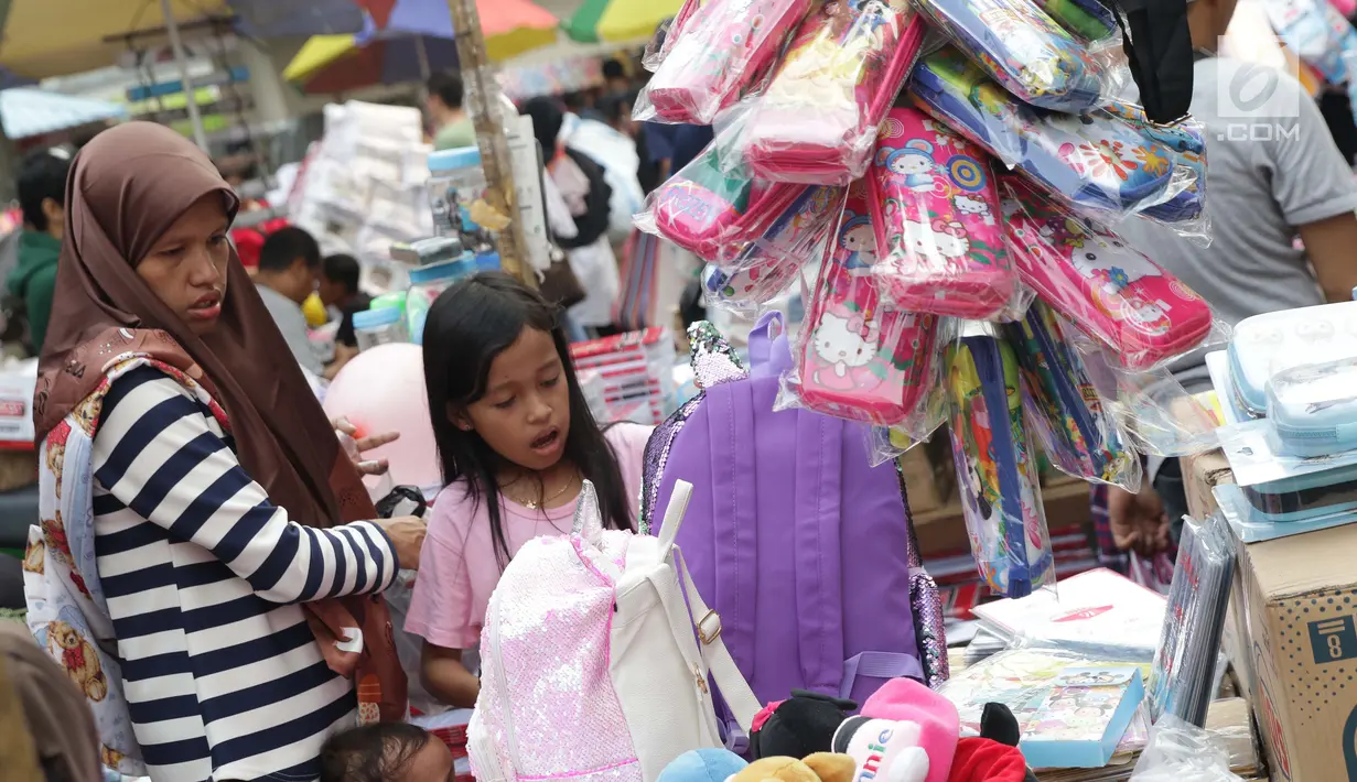 Seorang ibu bersama anaknya memilih keperluan sekolah di Pasar Asemka, Jakarta, Selasa (7/9/2019). Jelang dimulainya tahun ajaran baru, Pasar Asemka ramai dikunjungi warga untuk berbelanja keperluan sekolah. (Liputan6.com/Helmi Fithriansyah)