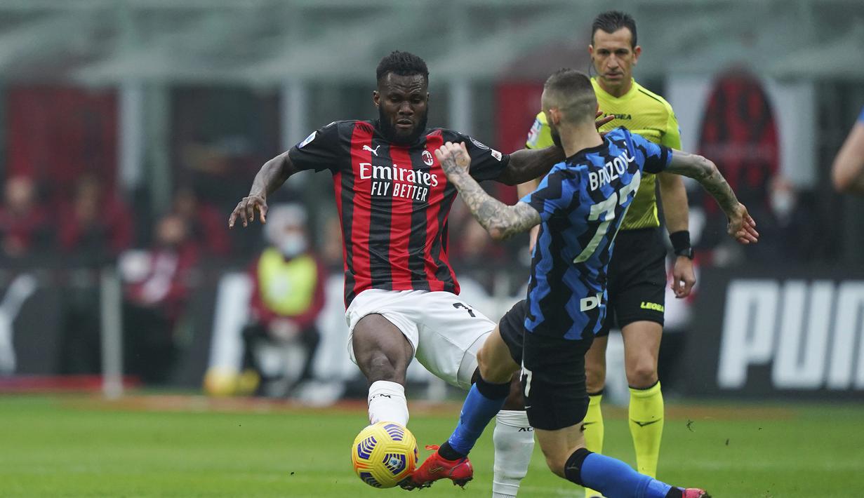 Gelandang AC Milan, Franck Kessie (kiri) berebut bola dengan gelandang Inter Milan, Marcelo Brozovic dalam laga lanjutan Liga Italia 2020/21 pekan ke-23 di San Siro Stadium, Minggu (21/2/2021). AC Milan kalah 0-3 dari Inter Milan. (LaPresse via AP/Spada)