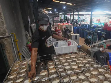 Pekerja menyelesaikan pembuatan kue keranjang di Pabrik Kue Hoki di kawasan Sawangan, Depok, Jawa Barat, Selasa (21/1/2025). (merdeka.com/Arie Basuki)