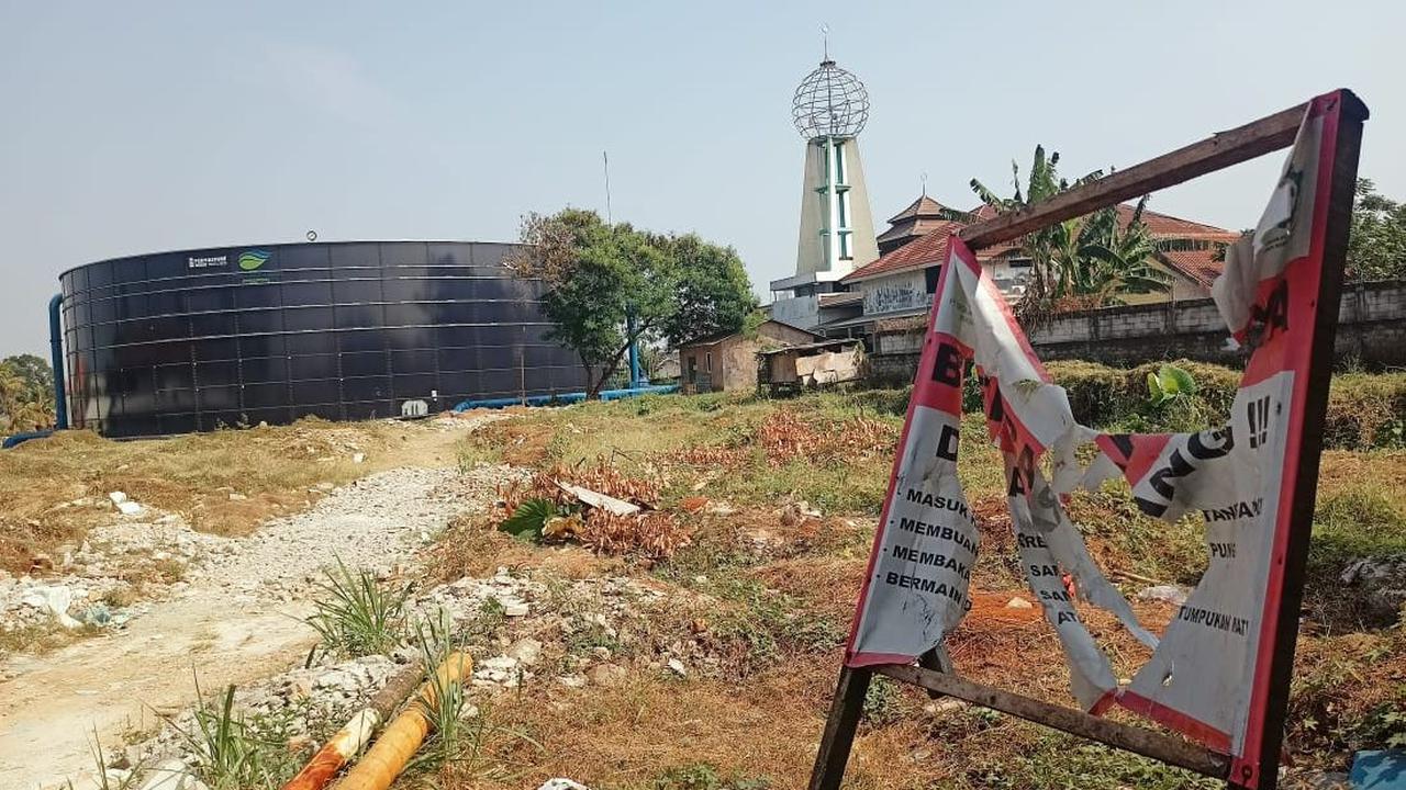 Tangki air raksasa itu memang berada sangat dekat dengan permukiman. Lokasinya hanya dibatasi dinding dengan Perumahan Pesona Depok.