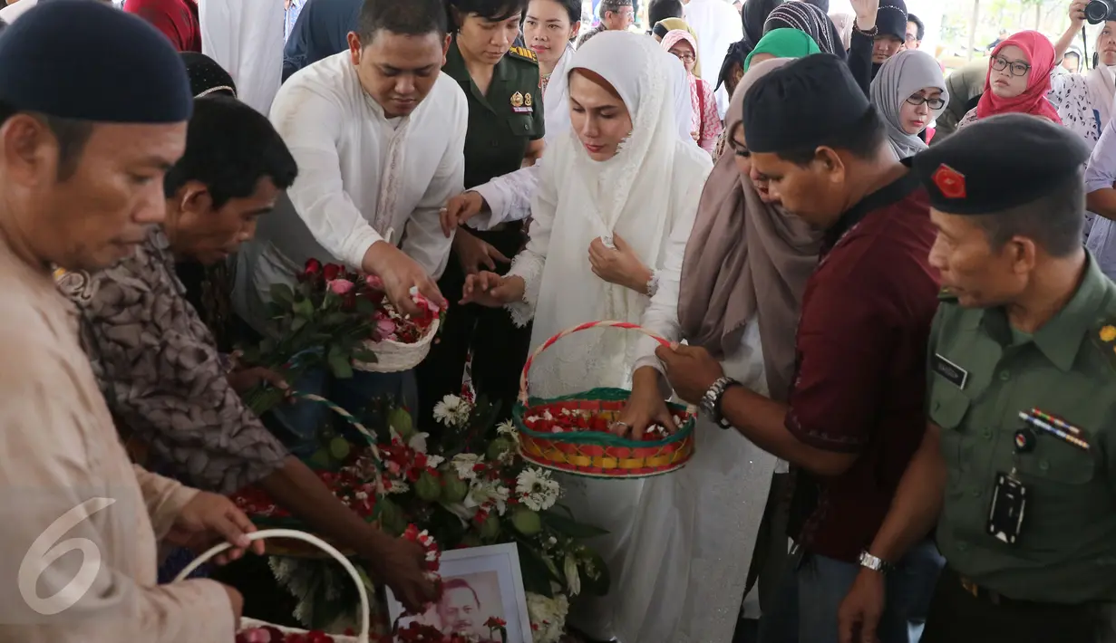 Marini Zumarnis beserta kerabat menabur bunga di makam ayahanda, Zumarnis Zein, di TPU Karet Bivak, Jakarta, Jumat (17/6). Ayah Marini Zumarnis meninggal di RSPAD Gatot Subroto pada usia 75 tahun karena komplikasi penyakit. (Liputan6.com/Herman Zakharia