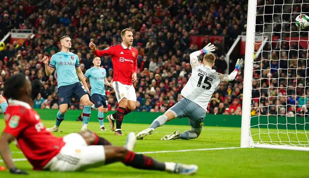 Pemain Manchester United Christian Eriksen mencetak gol ke gawang Burnley yang dijaga kiper Bailey Peacock-Farrell pada pertandingan sepak bola putaran keempat Piala Liga Inggris di Old Trafford, Manchester, Inggris, 21 Desember 2022. Manchester United  menang 2-0. (AP Photo/Dave Thompson)