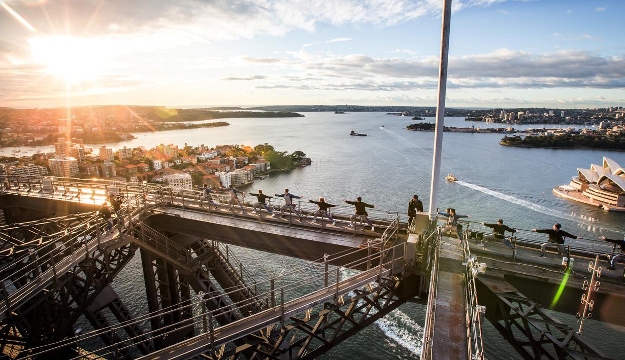 Sejumlah orang melakukan gerakan yoga untuk pertama kalinya di atas jembatan Sydney Harbour, Australia (21/6). Sejumlah negara di dunia sedang merayakan Hari Yoga Dunia yang jatuh pada tanggal 21 Juni. (Sydney BridgeClimb /REUTERS)