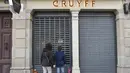 Pecinta sepak bola dunia berduka denagn meletakan bunga di depan Cruyff Store yang terdapat di Barcelona, Kamis (24/3/2016).  Bersama Ajax, Cruyff pernah meraih gelar Liga Champions sebanyak tiga kali. (AFP/Lluis Gene)