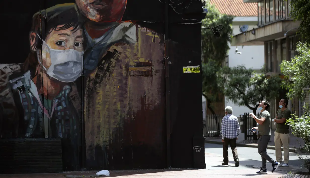 Sebuah mural menunjukkan seorang pemuda mengenakan masker selama pemerintahan setempat memberlakukan lockdown untuk mencegah penyebaran virus corona COVID-19 di Bogota, Kolombia, Senin (13/4/2020). (AP Photo/Fernando Vergara)