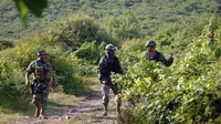 Polisi berjaga di lokasi penemuan kuburan massal di Meksiko. (News.com.au)
