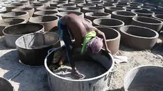 Bocah laki-laki Bangladesh menyelesaikan pembuatan toilet untuk pengungsi Rohingya di Sonarpara, Cox's Bazar, Rabu (11/10). Gelombang besar masuknya pengungsi Rohingya ke Bangladesh menyebabkan melonjaknya permintaan akan toilet. (INDRANIL MUKHERJEE/AFP)