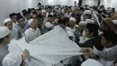 Umat muslim mengurus jenazah KH Maimun Zubair atau Mbah Moen usai dimandikan di Masjid Muhajirin Khalidiyah, Makkah, Arab Saudi, Selasa (6/8/2019). Jenazah Mbah Moen disemayamkan usai dimandikan di Masjid Muhajirin Khalidiyah Makkah. (Liputan6.com/HO/Baharuddin/MCH)