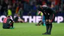 Pemain Arsenal, Alexandre Lacazette menutupi kepalanya dengan jersey usai kalah dari Atletico Madrid pada laga leg kedua semifinal Liga Europa di Wanda Metropolitano, Kamis (3/5). Arsenal tersingkir dari Liga Europa setelah kalah 0-1. (AP/Francisco Seco)