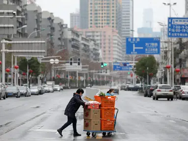 Warga membawa makanan dan sayuran di Wuhan di provinsi Hubei tengah China (3/3/2020). Hingga saat ini, jumlah total kasus virus corona secara global dilaporkan mencapai 89.770 kasus yang tersebar di sekitar 70 negara termasuk Indonesia. (AFP/STR)