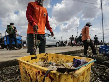 Petugas kebersihan membawa sampah laut di Pelabuhan Kali Adem, Jakarta, Senin (1/1). Banyaknya sampah plastik dibandingkan ikan yang gagal dikelola dengan baik membuat limbah yang mengakibatkan laut tercemar. (Liputan6.com/Faizal Fanani)
