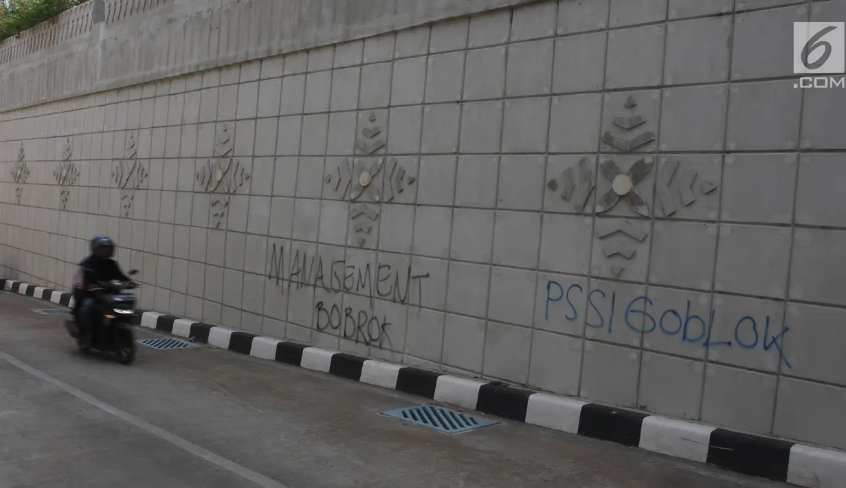 Pengendara motor melewati coretan di dinding underpass atau lintas bawah Matraman, Jakarta Selatan, Rabu (2/5). Corat-coret tersebut terpampang jelas ketika melintas dari arah Jalan Tambak menuju kawasan Pramuka. (Liputan6.com/Arya Manggala)