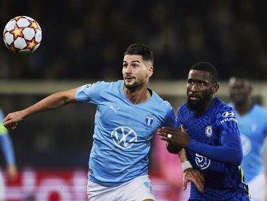 Gelandang Malmo, Erdal Rakip berebut bola dengan bek Chelsea, Antonio Rudiger pada matchday keempat Grup H Liga Champions di Eleda Stadion, Rabu (3/11/2021) dini hari WIB. Hakim Ziyech membawa Chelsea menang dengan skor tipis 1-0 atas Malmo. (Andreas Hillergren/TT News Agency via AP)