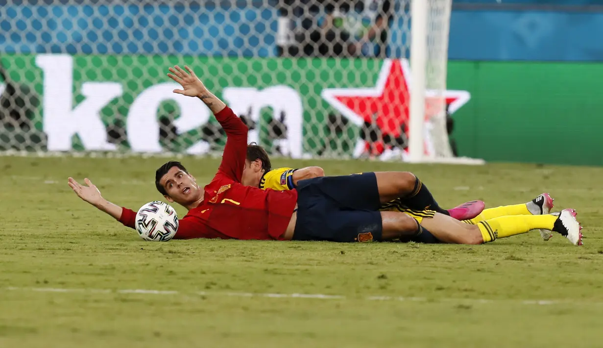 Penyerang Spanyol, Alvaro Morata terjatuh saat berebut bola dengan pemain Swedia, Albin Ekdal pada pertandingan grup E Euro 2020 di stadion La Cartuja di Seville, Spanyol, Senin (14/6/2021). Spanyol bermain imbang atas Swedia 0-0. (Jose Manuel Vidal/Pool via AP)
