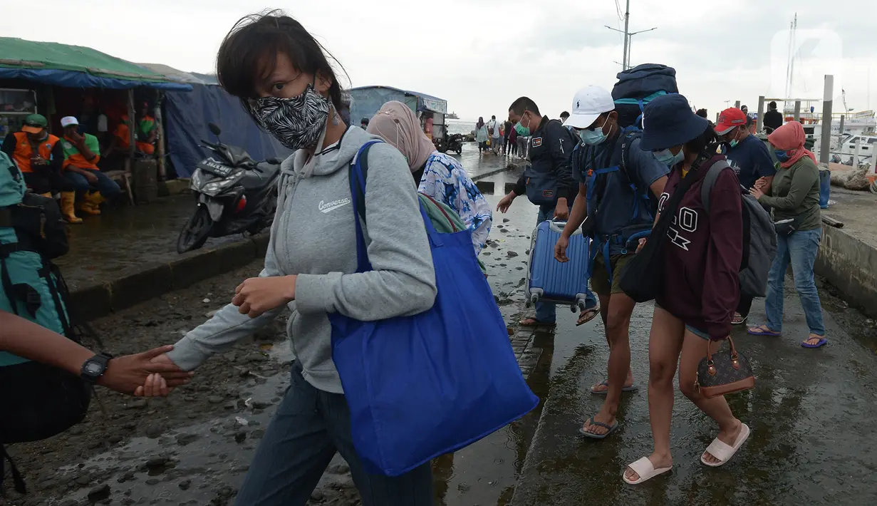 Wisatawan turun dari kapal tradisional usai perayaan malam pergantian Tahun Baru 2021 di Pelabuhan Kali Adem, Jakarta, Jumat (1/1/2021). Melalui pengawasan ketat, protokol kesehatan dipatuhi dan penyebaran COVID-19 dapat dikendalikan. (merdeka.com/Imam Buhori)