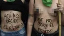 Wanita bertelanjang dada saat menggelar aksi di Buenos Aires, Argentina (29/9). Dekriminalisasi adalah penggolongan suatu perbuatan yang mulanya dianggap sebagai peristiwa pidana, tetapi kemudian dianggap sebagai perilaku biasa. (AFP Photo/Juan Mabromata)