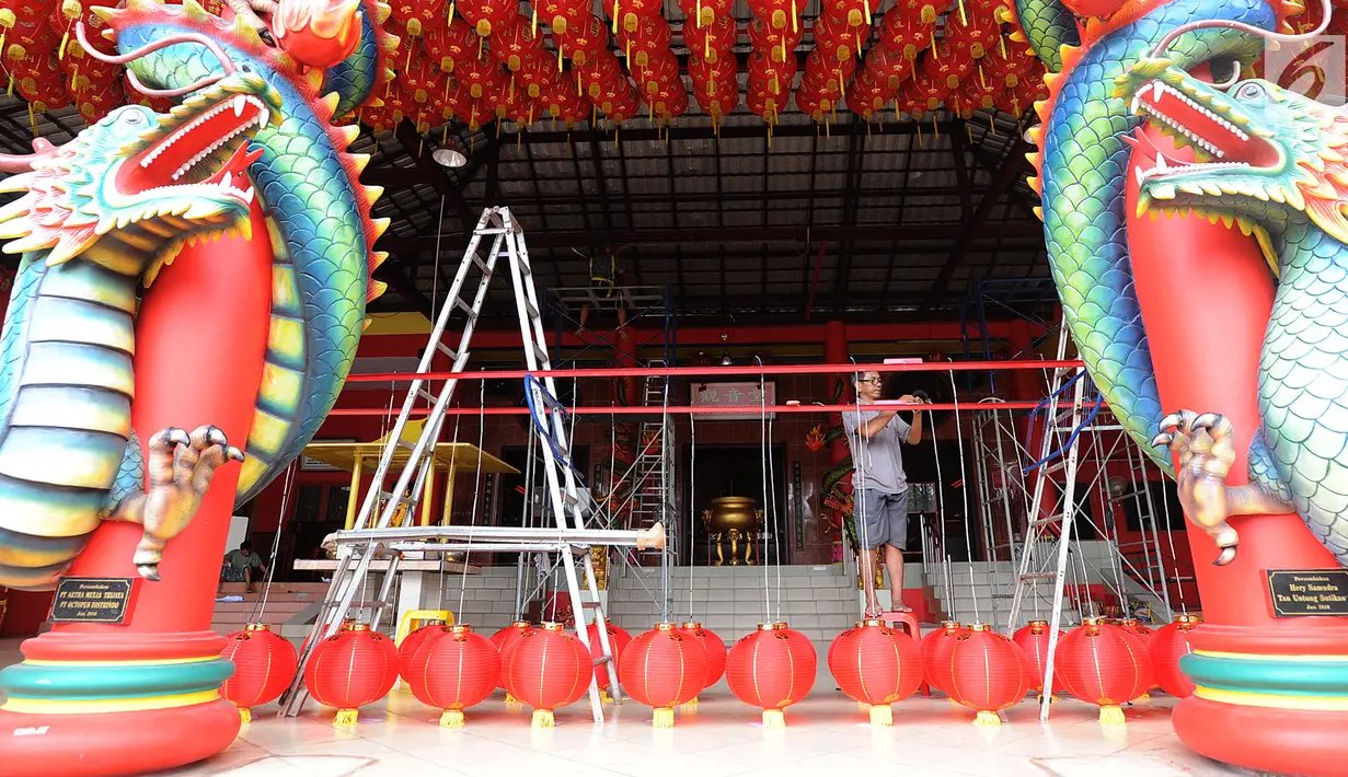 Seorang pria memasang lampion di Vihara Kwan In Thang Pondok Cabe, Tangerang Selatan, Banten, senin (28/1). Sepekan menjelang perayaan Tahun Baru China atau Imlek sejumlah vihara terus berbenah untuk mempercantik Vihara. (Merdeka.com/Arie Basuki)
