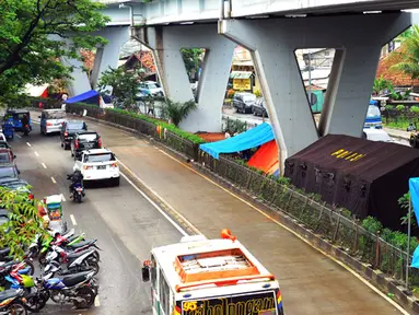 Sejumlah warga korban banjir mengungsi di bawah kolong Jembatan Pesing, Grogol, Jakarta, Rabu (11/2/2015). Tenda darurat mereka dirikan untuk bertahan sementara waktu. (Liputan6.com/Faisal R Syam)