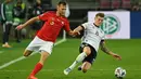 Gelandang Jerman, Toni Kroos, berebut bola dengan bek Swiss, Silvan Widmer, pada laga lanjutan UEFA Nations League 2020/2021 di RheinEnergie Stadion, Rabu (14/10/2020). Jerman bermain imbang 3-3 atas Swiss. (AFP/Ina Fassbender)