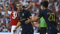 Gareth Bale mencetak gol untuk Real Madrid ke gawang AC Milan. (AFP/Andrew Caballero-Reynolds)