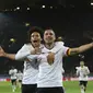 Striker Timnas Jerman Lukas Podolski merayakan golnya ke gawang Inggris dalam laga persahabatan di Signal Iduna Park, Kamis (23/3/2017) dinihari WIB. (Ina Fassbender/dpa via AP)