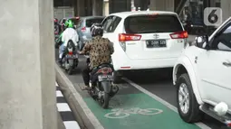 Kendaraan melintasi jalur sepeda di Jalan Fatmawati Raya, Jakarta Selatan, Kamis (21/11/2019). Pemprov DKI menerapkan tilang kepada para penerobos jalur sepeda setelah uji coba selama beberapa bulan. (Liputan6.com/Immanuel Antonius)