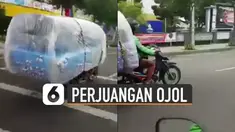 Beredar video memperlihatkan pengemudi ojek online memgangkut kasur dengan motor.