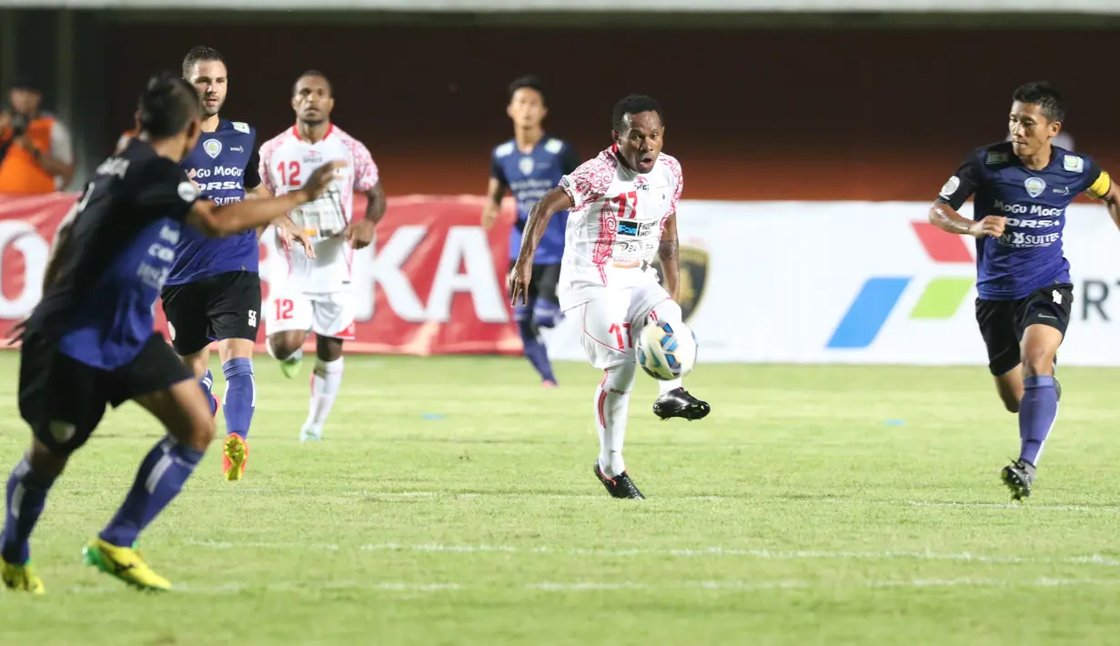 Pemain Persipura Jayapura, Ferinando Pahabol mengecoh para pemain Arema Cronus pada laga grup E Piala Jenderal Sudirman di Stadion Maguwoharjo, Sleman, Minggu (13/12/2015) (Bola.com/Nicklas Hanoatubun) 