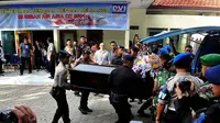 Tim DVI Polda Jawa Timur melakukan penyerahan jenazah korban pesawat AirAsia QZ8501 di RS Bhayangkara, Surabaya, Jumat (2/1/2015). Tampak, beberapa personil TNI-Polri memasukkan peti jenazah korban pesawat AirAsia QZ8501. (Liputan6.com/Johan Tallo)