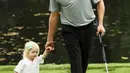 Pegolf Amerika Serikat, Webb Simpson membawa serta putrinya, Willow Grace Simpson pada hari terakhir mengikuti latihan untuk turnamen golf Masters 2018 di Augusta, Georgia, Rabu (4/4). (JAMIE Squire / Getty Images / AFP)