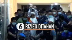 Polisi menahan pemimpin FPI Rizieq Shihab setelah memeriksanya sekitar 11 jam di Polda Metro Jaya. Minggu (13/12) dini hari, Rizieq keluar dari gedung pemeriksaan dengan baju tahanan dan tangan terborgol
