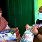 Wali Kota Bengkulu Helmi Hasan mendatangi rumah warga untuk megantarkan bantuan beras dan mie atau Rasmie serta menyelipkan selembar surat cinta. (Liputan6.com/Yuliardi Hardjo)