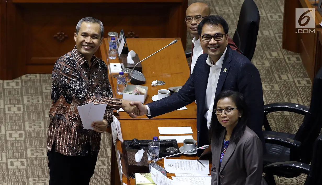 Calon Pimpinan KPK Alexander Marwata berjabat tangan dengan Ketua Komisi III DPR Aziz Syamsuddin (kanan) usai menerima amplop berisi tema makalah yang harus dibuat, saat uji kelayakan dan kepatutan capim KPK di Kompleks Parlemen, Senayan, Jakarta, Senin (9/9/2019). (Liputan6.com/Johan Tallo)