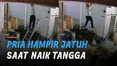 Hampir saja jatuh dari tangga. Pria ini masih bisa bergelantungan di bagian atas gedung.