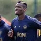 Gelandang Manchester United, Paul Pogba, tersenyum saat latihan di Kompleks Carrington, Manchester, Selasa (2/10/2018). Latihan ini persiapan jelang laga Liga Champions melawan Valencia. (AFP/Lindsey Parnaby)