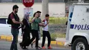 Reaksi warga menyusul ledakan sebuah bom mobil yang menghantam kendaraan lapis baja polisi di Kota Diyarbakir, Turki, Selasa (10/5). Seorang saksi di lokasi kejadian mendengar ledakan keras di pusat kota diikuti oleh suara sirine. (REUTERS/Sertac Kayar)