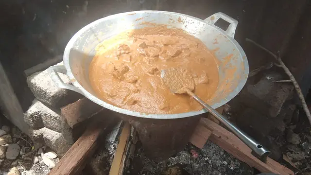Memasak rendang menggunakan tungku