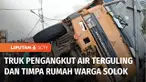 Tak kuat menanjak, truk pengangkut air mineral terguling dan menimpa rumah di jalan raya lintas nasional Gunung Talang, Kabupaten Solok, Sumatra Barat.
