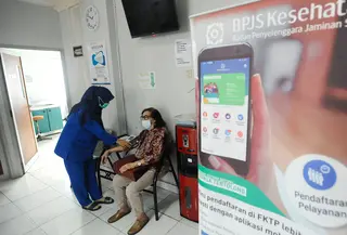 Petugas memeriksa tekanan darah pasien BPJS Kesehatan yang berobat di Faskes Tingkat 1 Klinik Kesehatan Prima Husada di Depok, Jawa Barat, Senin (23/5/20222). Sejumlah terobosan saat ini dilakukan paramedis di Faskes Tingkat 1, diantaranya penilaian peserta program JKN melalui fitur Kessan (Kesan Pesan Peserta Setelah Layanan)  dalam aplikasi Mobile JKN. (merdeka.com/Arie Basuki)
