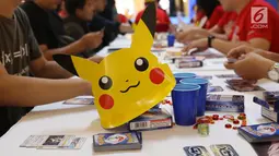 Para pecinta kartu pokemon bermain kartu The Pokémon Trading Card Game di  Kota Kasablanca, Jakarta, Kamis (8/8/2019). Di pasar global, permainan tukar kartu itu telah terjual sebanyak 27,2 miliar kartu hingga Maret 2019 dengan segmentasi anak-anak hingga dewasa. (Liputan6.com/Angga Yuniar)