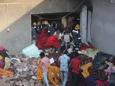 Tim penyelamat mencari korban yang selamat di lokasi kebakaran di pabrik di kawasan industri di Ahmedabad, India, Rabu (4/11/2020). Menurut pejabat setempat, puluhan orang tewas ketika sebagian gudang bahan kimia runtuh setelah terjadi ledakan dahsyat. (AP Photo/Ajit Solanki)