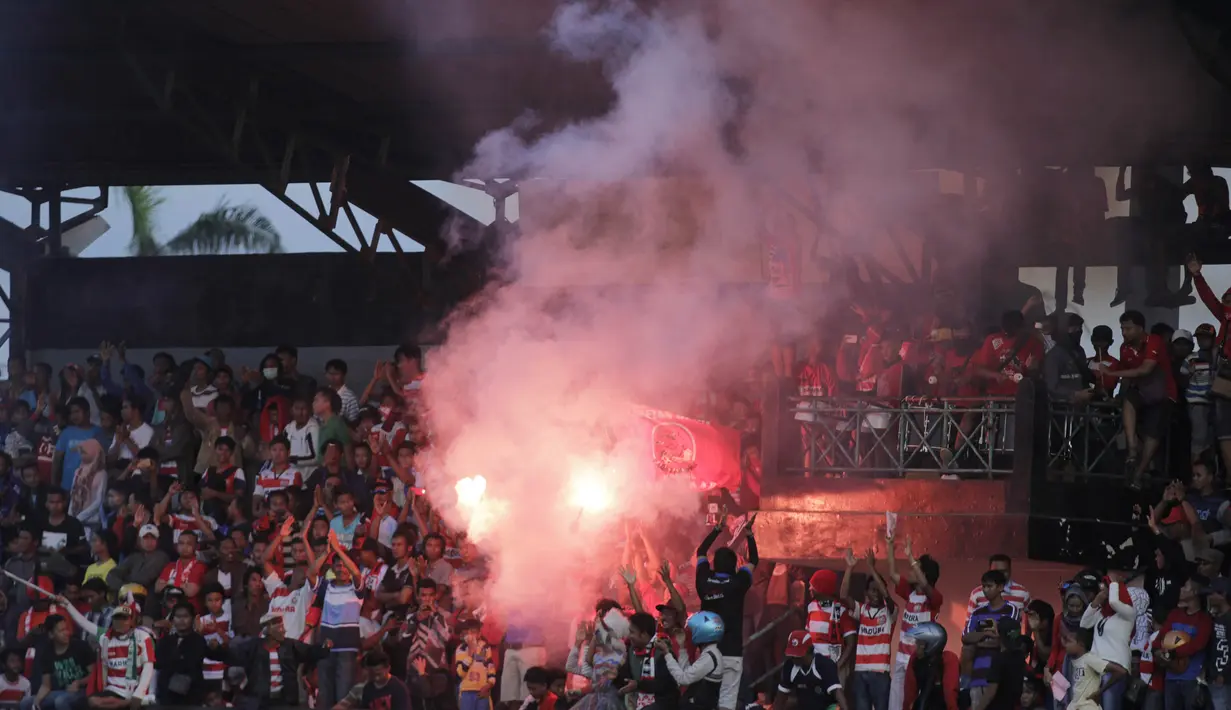 Para suporter menyalakan suar usai menyaksikan laga uji coba antara Madura United melawan Persiba Balikpapan. (Bola.com/Vitalis Yogi Trisna)