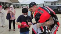 Pembalap Ducati Aruba Racing Scott Redding melayani permintaan tanda tangan penggemarnya usai WSBK Mandalika di Sirkuit Mandalia, Lombok, NTB, Minggu (21/11/2021). (foto: Liputan6.com/Septian Pamungkas)