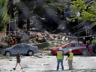 Pemadam kebakaran mengamati puing bangunan apartemen di Sivler Spring, Maryland, Washington DC, Kamis (11/8). Sedikitnya 2 orang tewas dan tujuh lainnya hilang setelah ledakan gas alam yang menyebabkan kebakaran di apartemen itu. (REUTERS/Joshua Roberts)
