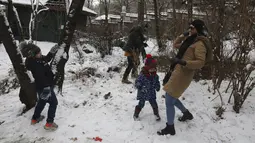 Orang-orang bermain dengan salju saat menghabiskan akhir pekan mereka di sebuah taman di Teheran utara, Iran, Jumat (25/12/2020). Iran berjuang melawan virus corona sangat terhambat oleh sanksi AS yang dijatuhkan pemerintahan Donald Trump. (AP Photo/Vahid Salemi)