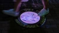 Dalam gambar yang diambil pada 20 Agustus 2020 ini, seorang pejalan kaki berjalan di atas penutup lubang berlampu Re:Zero − Starting Life in Another World" oleh Otsuka Shinichiro di Tokorozawa, Saitama Prefecture, Jepang. (PHILIP FONG / AFP)