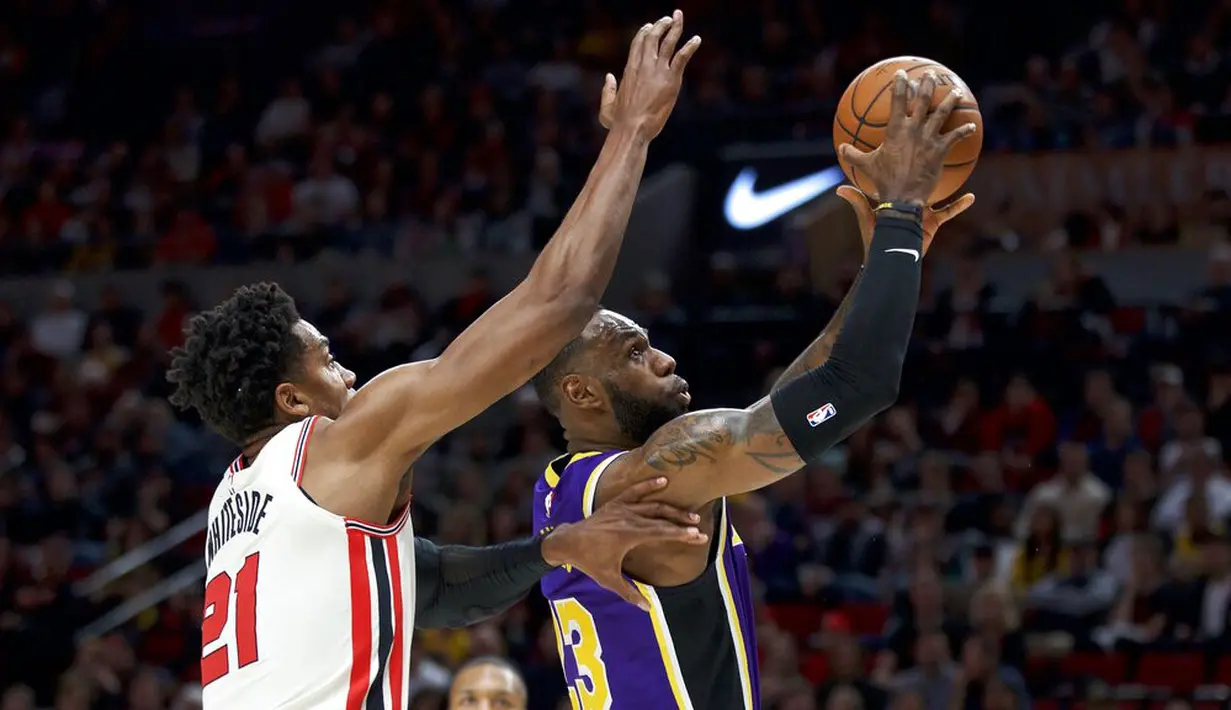 Pebasket Los Angeles Lakers, LeBron James, berusaha memasukan bola saat melawan Portland Trail Blazers di Moda Center, Sabtu 928/12). LA Lakers menang 128-120 atas Portland Trail Blazers. (AP/Craig Mitchelldyer)
