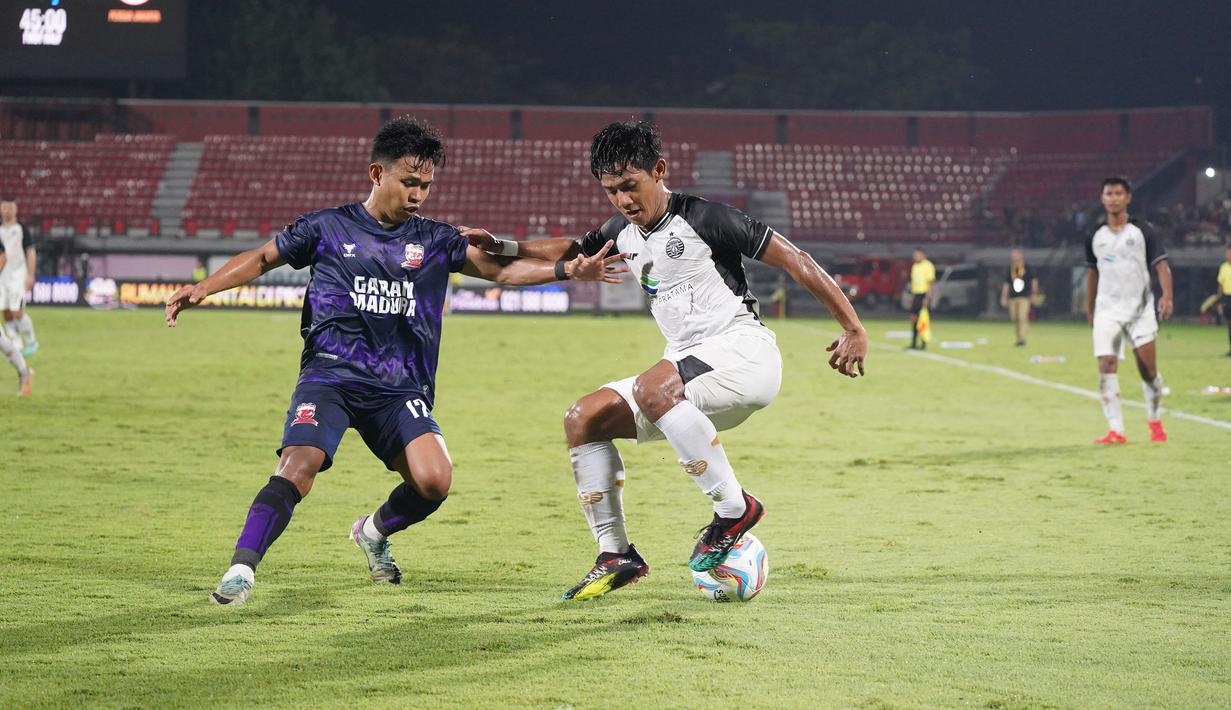 <p>Bek Persija Jakarta, Firza Andika menguasai bola dibayangi sayap kiri Madura United, Irfan pada laga Grup B Piala Presiden 2024 di Stadion Kapten I Wayan Dipta, Gianyar, Bali, Minggu (21/7/2024). (Dok. Persija)</p>